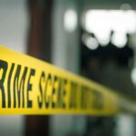 Wearable Data Could Help Solve Missing Man Case crime scene tape in a blurred indoor setting
