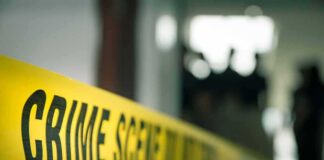 crime scene tape in a blurred indoor setting