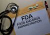 FDA document with stethoscope, pills, and pencil on envelope