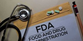 FDA document with stethoscope, pills, and pencil on envelope