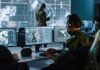 Military analysts at computers in a command center