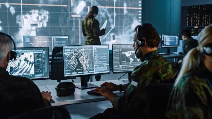 shutterstock_1936992973 Military analysts at computers in a command center