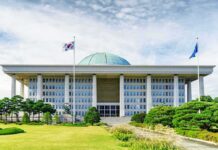 South Korea’s Stock Boom Turns Into a Billion-Dollar Backlash Parliament building with a green dome and flagpoles