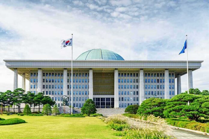 shutterstock_749891683 Parliament building with a green dome and flagpoles