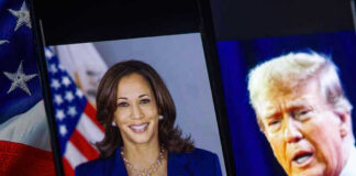 Kamala Harris and Donald Trump shown on adjacent screens with a U.S. flag nearby