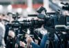 Women’s NBA Sideline Erupts — Culture War Hits Court Broadcast cameras on tripods at a press event