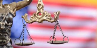 Lady Justice scales with American flag background