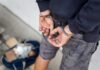 Influencer Bombshell: Rape, Drugging Allegations Person in handcuffs with hands behind back