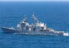 Gray naval warship cruising on open sea