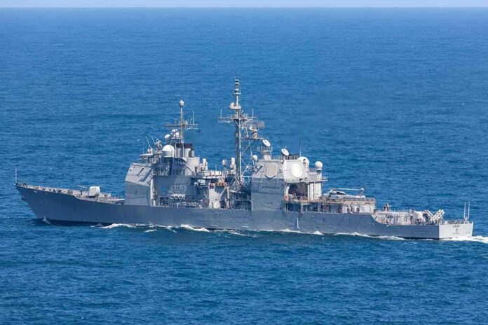 shutterstock_1408246997-1 Gray naval warship cruising on open sea