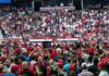 Trump Pauses After Rally Heckling Crowd at a political rally facing a podium