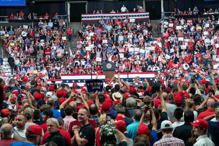 shutterstock_1480255847-1 Crowd at a political rally facing a podium