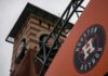 Houston Wins Division Without Winning Record Houston Astros logo on orange sign near ballpark clock tower