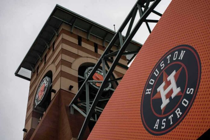shutterstock_1649223655-1 Houston Astros logo on orange sign near ballpark clock tower