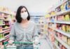 Lettuce Probe Intensifies as Cases Climb Woman wearing mask shopping in a supermarket aisle