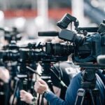 Foiled Drone Threat at White House UFC Event Broadcast cameras on tripods at a press event