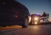 Lottery Winner Found Asleep in Running Car Police officer at patrol car during traffic stop at dusk