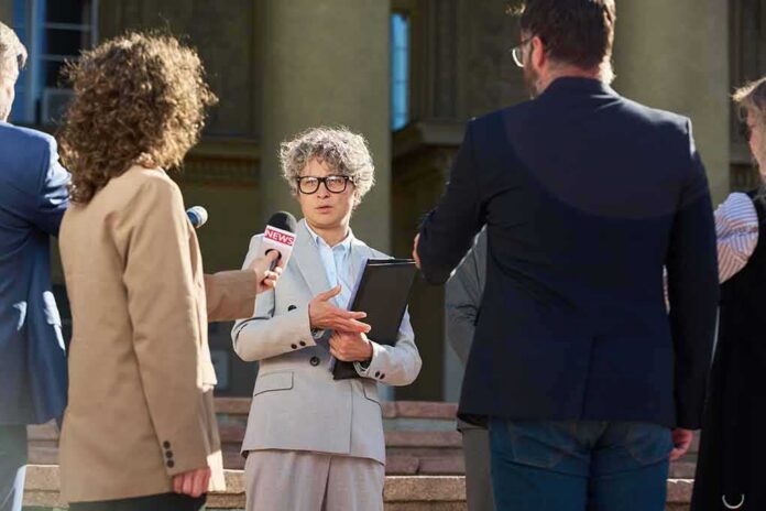 shutterstock_2690323305 Spokesperson addresses reporters on courthouse steps