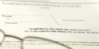 Subpoena document with reading glasses