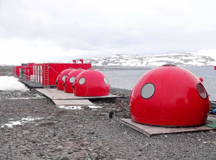 shutterstock_380025196-1 Red dome shelters at a polar research station by the sea