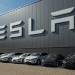 Tesla Unveils $30,000 Cybercab Robotaxi Tesla cars parked outside a large Tesla building