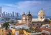 historic church with domes overlooking a coastal city skyline