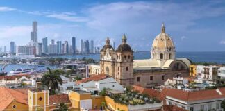 historic church with domes overlooking a coastal city skyline