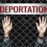 Military Families Face Deportation Fears Hands gripping chain-link fence with deportation sign