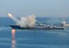 U.S. Strikes Iranian Launchers Near Hormuz Warship launching a missile at sea