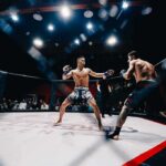 White House UFC Setup Draws Praise, Lawsuit, Scrutiny Two MMA fighters square off in a caged octagon