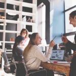 Scandal Hits NYT – White Male Snubbed Coworkers collaborating at a desk in a modern office