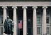 Medicare Part B Enrollees Set to Receive $90 Statue in front of a neoclassical government building with columns and a U.S. flag