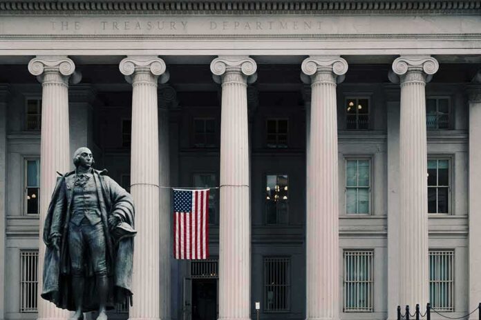 shutterstock_1240657660 Statue in front of a neoclassical government building with columns and a U.S. flag