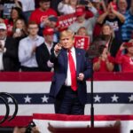 Trump Pushes Alaska Gas Project at Campaign Rally Donald Trump points from a rally stage; Rudi Koertzen and Bear Pascoe are in the crowd