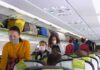 Cockpit Chaos: Midair Knife Fight Passengers with masks boarding an airplane cabin