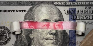 portrait on banknote with torn strip revealing red eyes