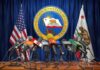 California Homelessness Spending Faces Scrutiny Press microphones at a podium before California governor seal