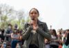 Arizona Candidate’s Police Funding Record Draws Scrutiny woman speaking into a microphone at an outdoor rally
