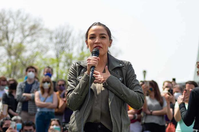 shutterstock_1962940828-1 woman speaking into a microphone at an outdoor rally