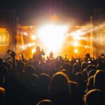 Racism in Metal Culture Sparks Debate Crowd at a nighttime concert with bright stage lights
