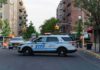 Man Shot During Federal Immigration Operation NYPD police SUV blocking a city street at a taped-off scene