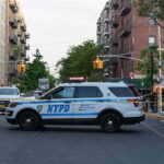 Man Shot During Federal Immigration Operation NYPD police SUV blocking a city street at a taped-off scene