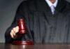 Murder Trial Could Be Delayed Until 2029 Judge with gavel striking sound block