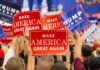 Rainy Rally Draws Strong Oklahoma Crowd Crowd holding red and blue campaign signs at a political rally