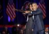 Obama Targets Michigan as Early Voting Opens Michelle Obama and Rob Nabors pointing on stage at an event