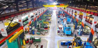 Aerial view of a large industrial workshop filled with various machinery and equipment